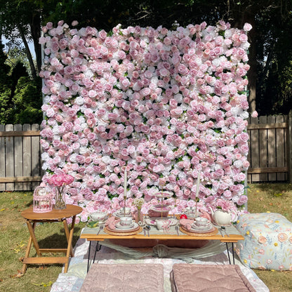 Floral wall backdrop with a table set for a meal outdoors